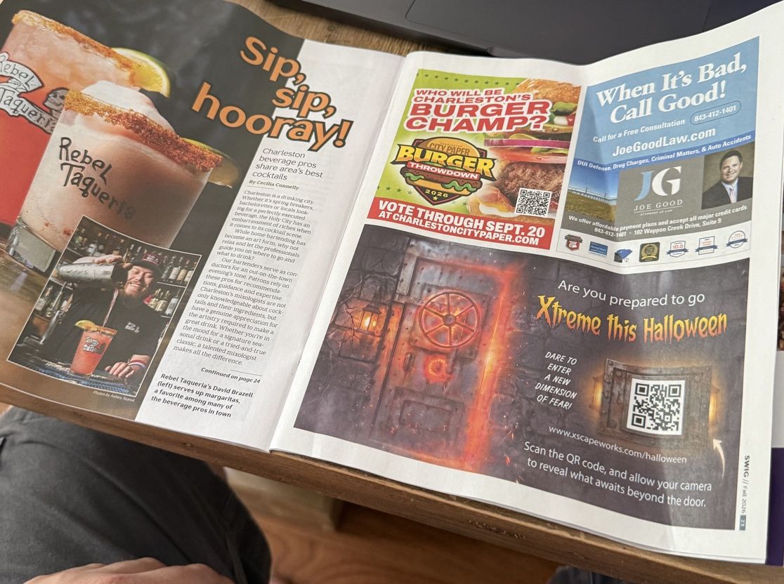 The full open newspaper with the XscapeWorks door advertisement on the right-hand page